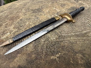 An unusual knife styled as a 17th century plug bayonet. No markings visible.