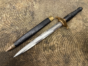 An unusual knife styled as a 17th century plug bayonet. No markings visible.