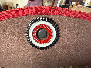A lovely and scarce **Cameroon Schutztruppe Südwester**, unfortunately missing its original sweatband. Believed to be an officer’s example, as the quality is better than that normally seen on other ranks’ examples, and the cockade is of an unusual pattern.

The Südwester was perhaps the most famous and distinctive headgear of the Schutztruppe. It was worn by all ranks on most occasions in South West Africa, as well as on home duties in Germany. In East Africa and Cameroon it was less widely used, often being replaced by the tropical helmet while on active service.

Made from grey felt, the hat was turned up on the right-hand side and secured by a large metal Imperial cockade in black, white and red. The hatband ribbon and edging varied according to colony: blue for South West Africa, white for East Africa and red for Cameroon.

Officers’ and senior NCOs’ Südwesters were often privately tailored and were generally of better quality and more elaborate than standard other ranks’ examples, sometimes featuring wider ribbons, edging and larger or more elaborate cockades. On some examples, silver was used in place of white.

The Südwester was a source of pride for the Schutztruppe as well as a practical piece of kit, providing shade from the sun during the day and even being rolled up for use as a pillow at night.

Being offered for sale on consignment.