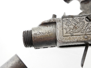 A lovely early 19th-century English 40-bore boxlock percussion muff pistol by Henry Nock of London, converted from flintlock and with the original sliding safety catch removed. It features a 1.5-inch turn-off barrel bearing Birmingham proof marks, while the action is finely engraved with war trophies and signed “H. Nock, London.”