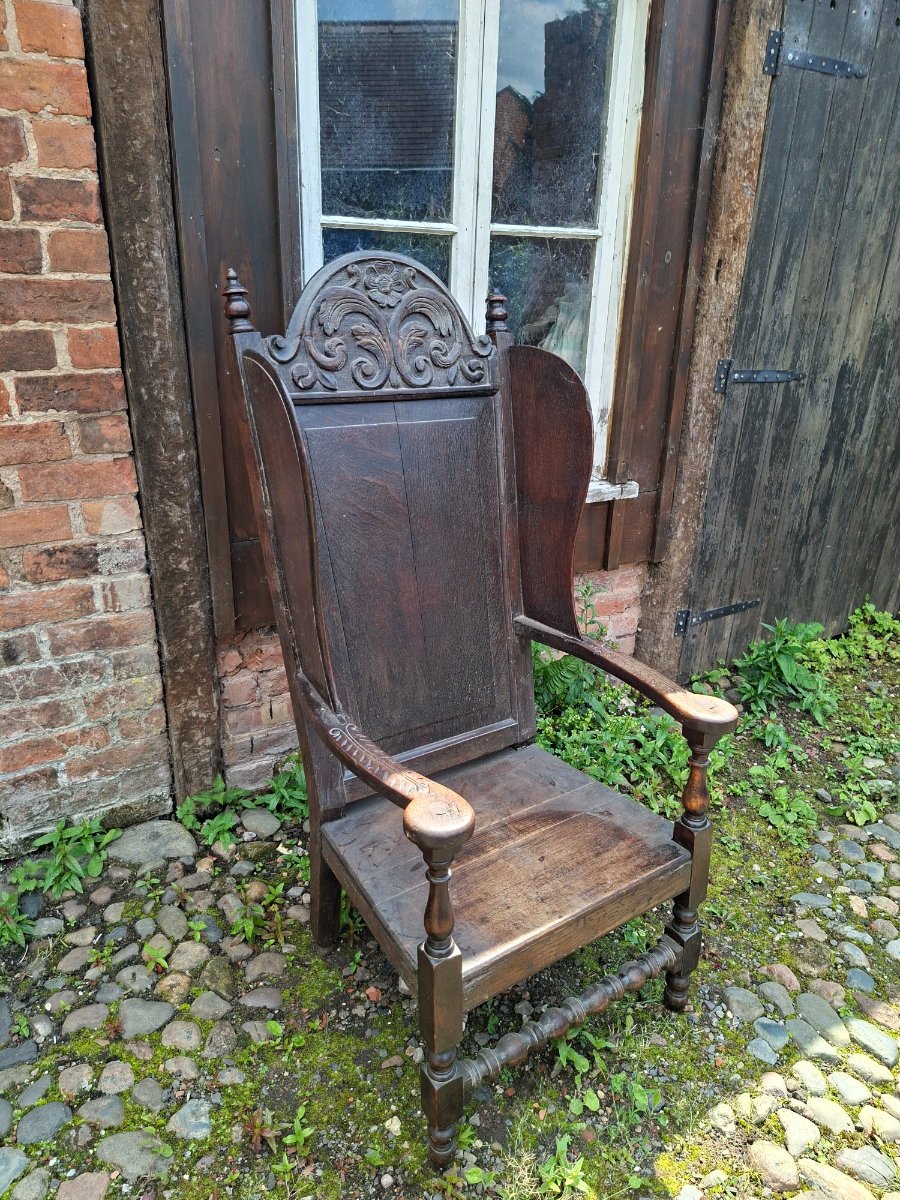 Discover our 17th-century carved oak lambing chair with Tudor flower detailing. Size H 136 x W 64 x D 60 cm. Explore now for top quality vintage furniture.
