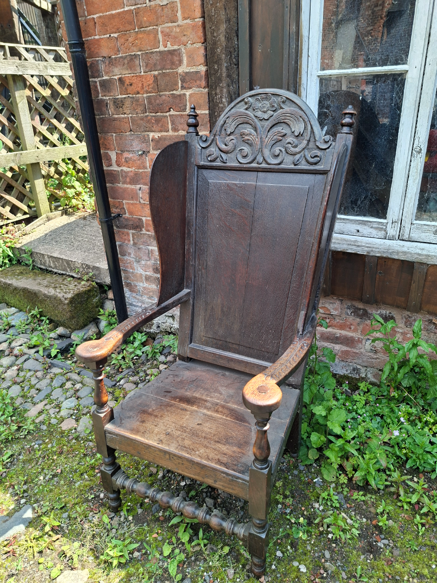 Discover our 17th-century carved oak lambing chair with Tudor flower detailing. Size H 136 x W 64 x D 60 cm. Explore now for top quality vintage furniture.