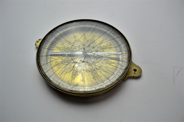 Discover the charm of our late 18th-century brass surveying compass, featuring a rock crystal front! Explore now and connect with history.