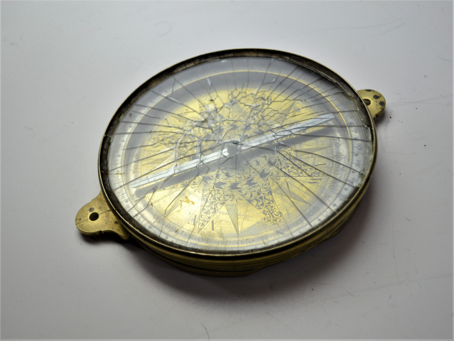 Discover the charm of our late 18th-century brass surveying compass, featuring a rock crystal front! Explore now and connect with history.
