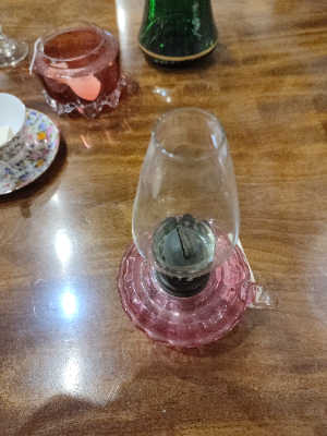 Discover our elegant Small Glass Cranberry Oil Lamp. Brighten your space with its unique design and top-notch quality. Order today for a captivating glow in your home!