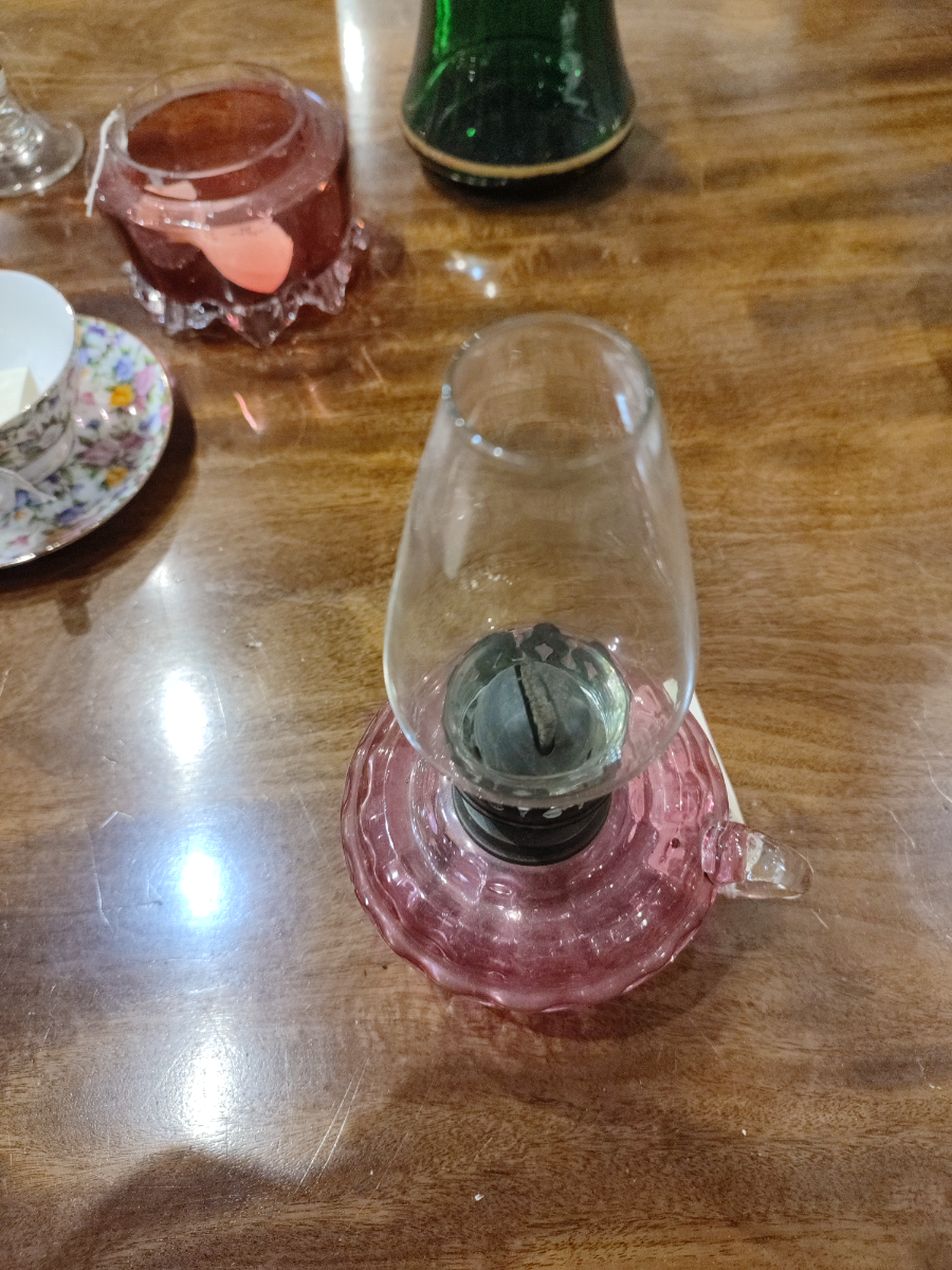 Discover our elegant Small Glass Cranberry Oil Lamp. Brighten your space with its unique design and top-notch quality. Order today for a captivating glow in your home!