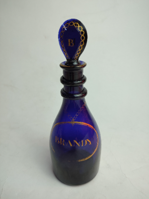 Discover our stunning Bristol Blue Brandy Decanter, circa 1810, with original lozenge stopper. Shop now for this rare 23cm high, gilded vintage treasure.