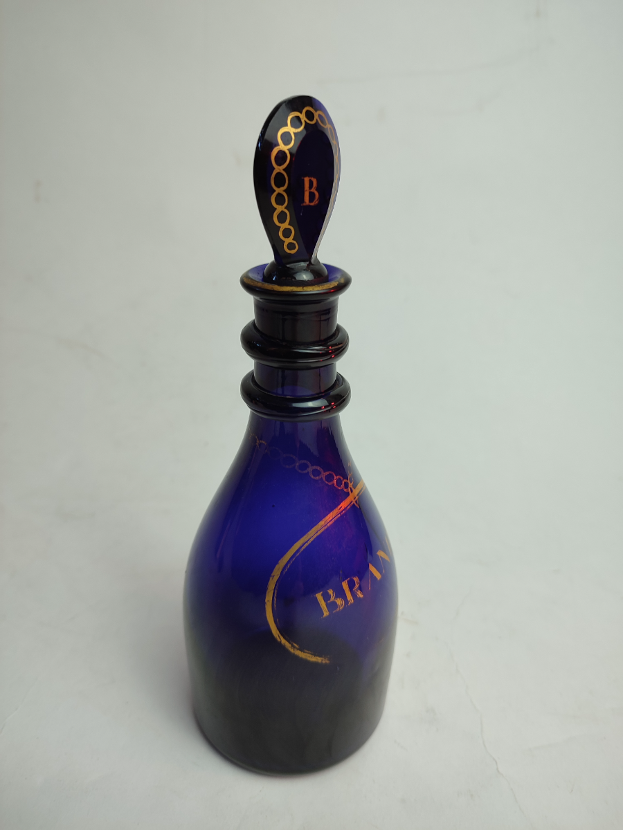 Discover our stunning Bristol Blue Brandy Decanter, circa 1810, with original lozenge stopper. Shop now for this rare 23cm high, gilded vintage treasure.