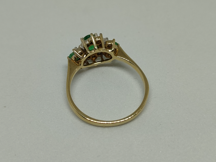 A 9 ct Gold Emerald And Diamond Cluster Ring