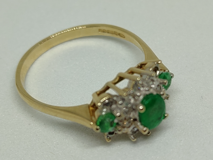 A 9 ct Gold Emerald And Diamond Cluster Ring