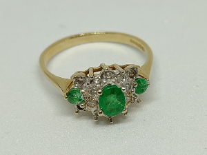 A 9 ct Gold Emerald And Diamond Cluster Ring