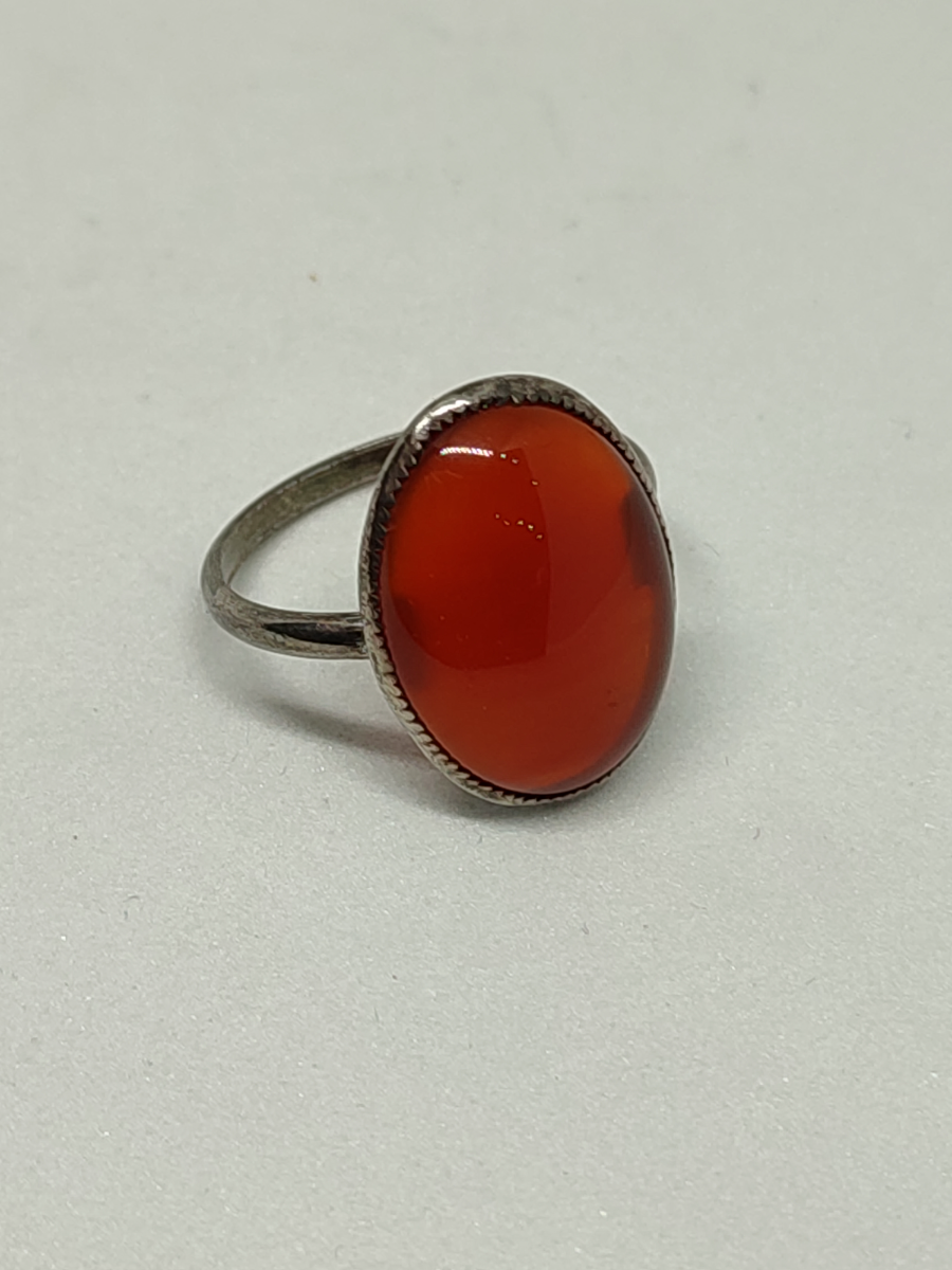 Discover our collection of white metal rings. Get enchanted by a unique piece with an orange stone. Top quality materials. Book a free consultation today!