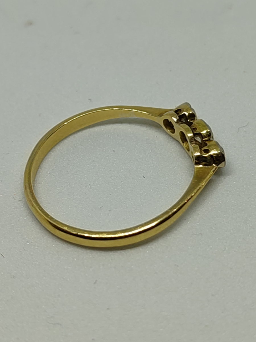 Discover our 18ct gold three stone diamond ring. Featuring 0.40ct diamonds, weighing 2.3g, and available in size R/S. Shop now for timeless elegance.