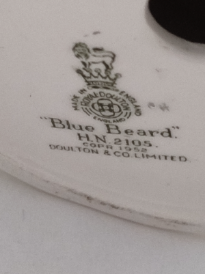 Discover our Royal Doulton figurine, a vintage gem from 1952. Add the memorable blue-beard man HN2105 to your collection today. Shop now to secure this rare piece!