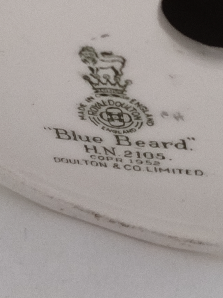 Discover our Royal Doulton figurine, a vintage gem from 1952. Add the memorable blue-beard man HN2105 to your collection today. Shop now to secure this rare piece!