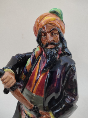 Discover our Royal Doulton figurine, a vintage gem from 1952. Add the memorable blue-beard man HN2105 to your collection today. Shop now to secure this rare piece!