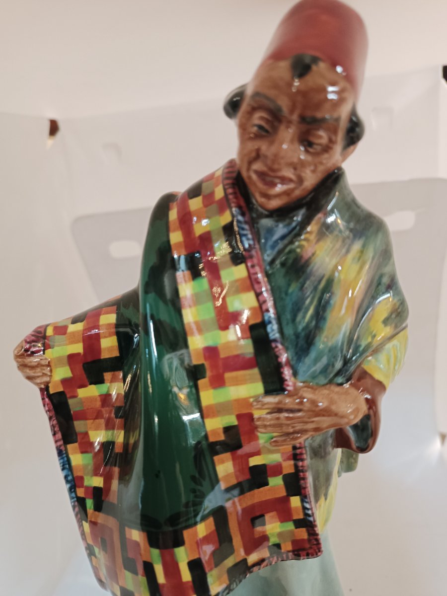 Discover our Royal Doulton Carpet Seller figure designed by Charles Noke. Shop now to bring home this 23cm porcelain masterpiece in good condition.
