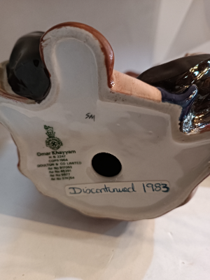 Shop our Royal Doulton Omar Khayyam figure, an exquisite piece of discontinued porcelain crafted by Mary Nicole. Perfect for collectors - secure yours today!