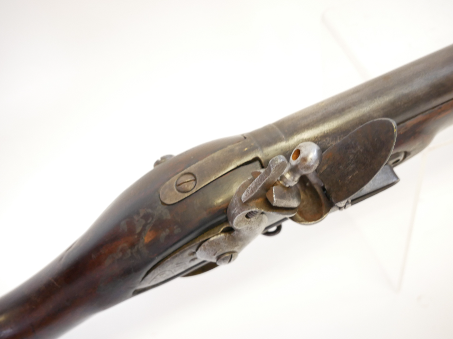 Discover the .750 Brown Bess Flintlock Musket from East India Company. Made in 1798, adorned with EIC crest, Indian arsenal marks and brass fittings. Explore now!