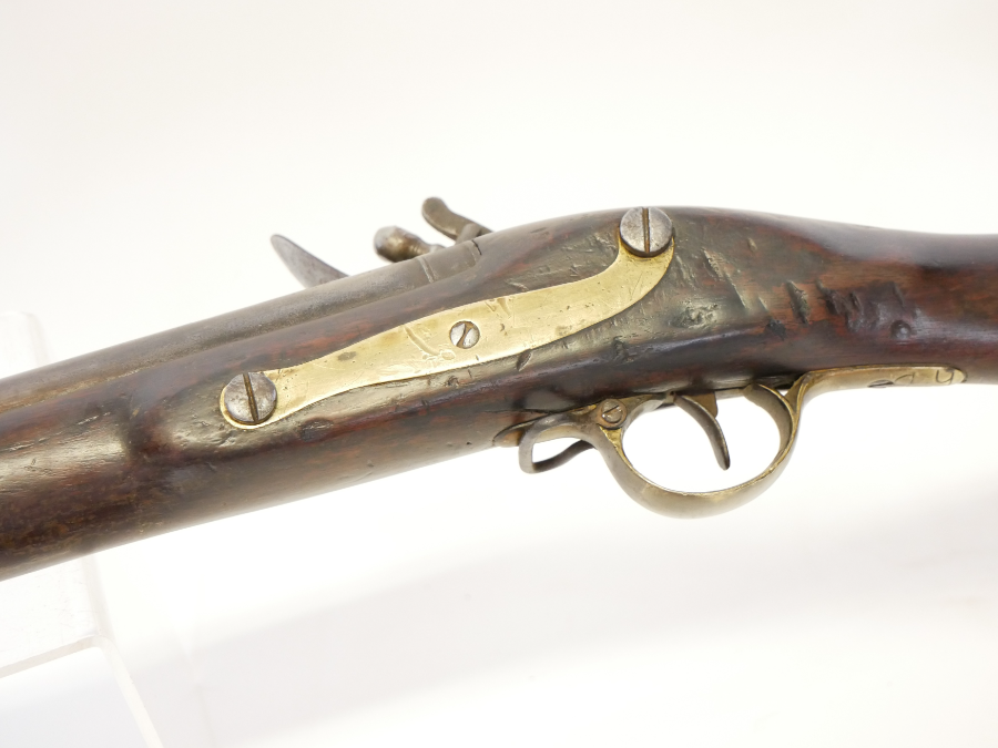 Discover the .750 Brown Bess Flintlock Musket from East India Company. Made in 1798, adorned with EIC crest, Indian arsenal marks and brass fittings. Explore now!