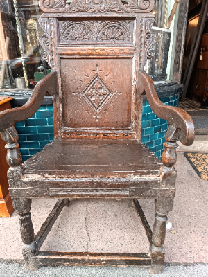 Discover our rare 17th-century oak wainscot armchair from Leeds, Yorkshire. Admire its high-quality scroll-carved top rail, lozenge-carved panel, and check inlaid border. Shop now!