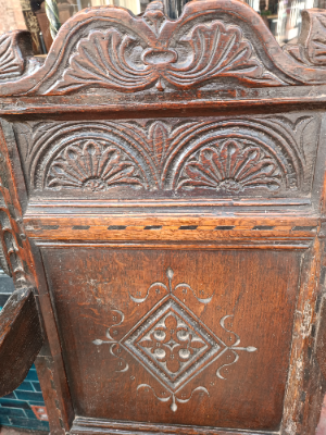 Discover our rare 17th-century oak wainscot armchair from Leeds, Yorkshire. Admire its high-quality scroll-carved top rail, lozenge-carved panel, and check inlaid border. Shop now!