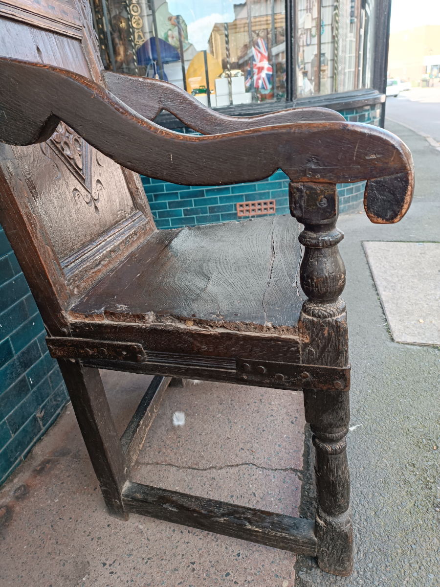 Discover our rare 17th-century oak wainscot armchair from Leeds, Yorkshire. Admire its high-quality scroll-carved top rail, lozenge-carved panel, and check inlaid border. Shop now!