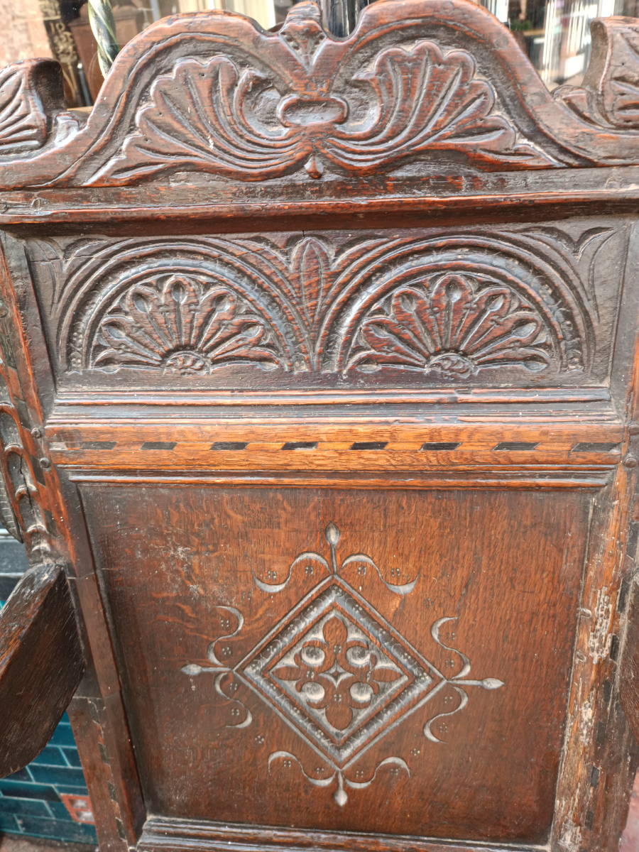 Discover our rare 17th-century oak wainscot armchair from Leeds, Yorkshire. Admire its high-quality scroll-carved top rail, lozenge-carved panel, and check inlaid border. Shop now!