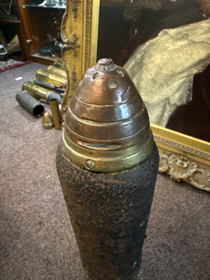 An 18 pounder artillery round dated February 1916. Fuse no longer screws to casing. Length 56cm.