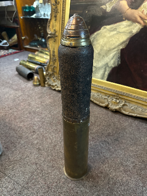 An 18 pounder artillery round dated February 1916. Fuse no longer screws to casing. Length 56cm.