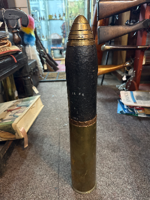A lovely inert 18 pounder artillery shell. Case dated 1917. Shell dated 1913 and marked OF 18 PR FGI 1913. Total length 58cm.