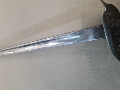 Discover our unique SNCO 1897 Edward VII Sword without scabbard, bend tested and WD marked, dated May 1903. Experience history in the palm of your hand. Shop now!