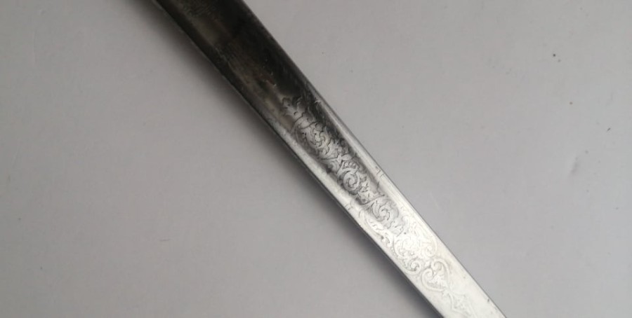 Discover our 1897 Victorian Indian officers sword, originally owned by a Regular officer and later used by the Calcutta Scottish Regiment. Features unique thistles insignia, queen's crown, and a historical badge. Shop now and own a piece of history!