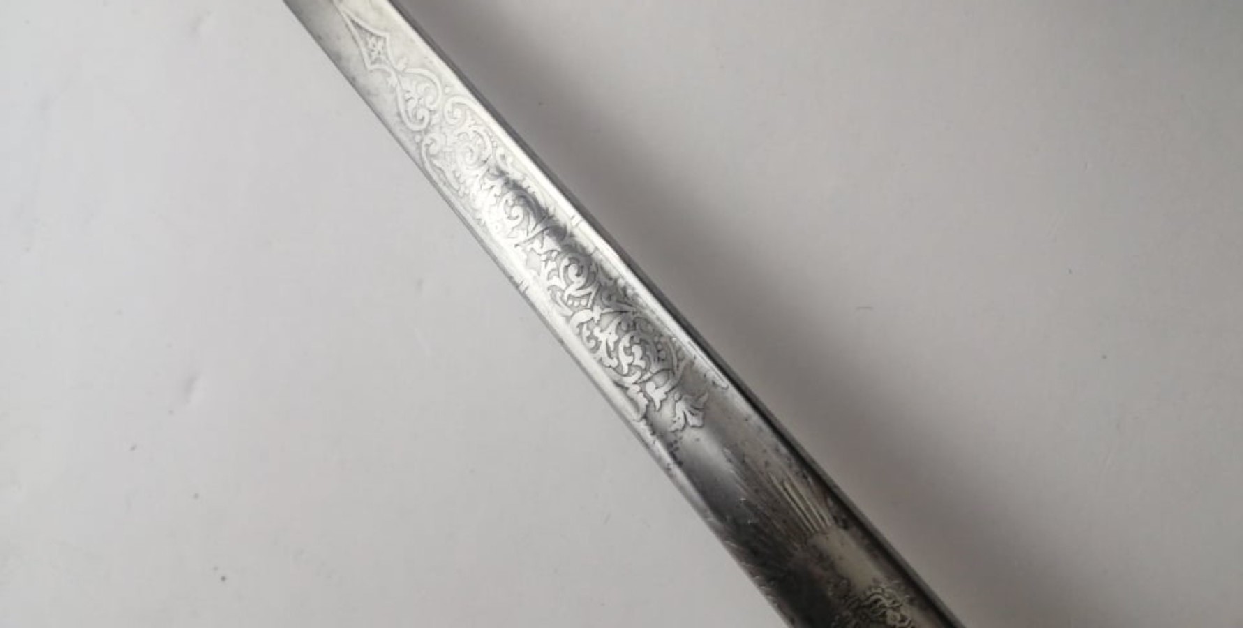 Discover our 1897 Victorian Indian officers sword, originally owned by a Regular officer and later used by the Calcutta Scottish Regiment. Features unique thistles insignia, queen's crown, and a historical badge. Shop now and own a piece of history!