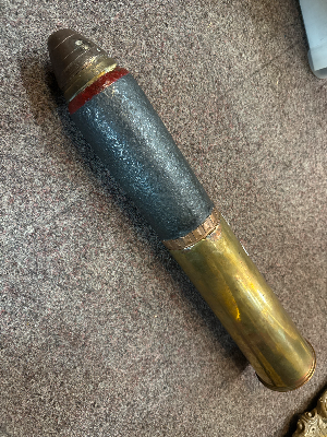 An inert 18 pounder artillery shrapnel round. Casing dated 1916. Length 57cm.