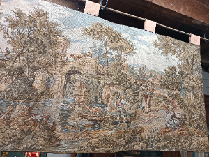 A 20th century Tapestry depicting a couple in ideallic landscape with lining.  It has loops on top for hanging on the wall.  Size 120 x 65 cm.