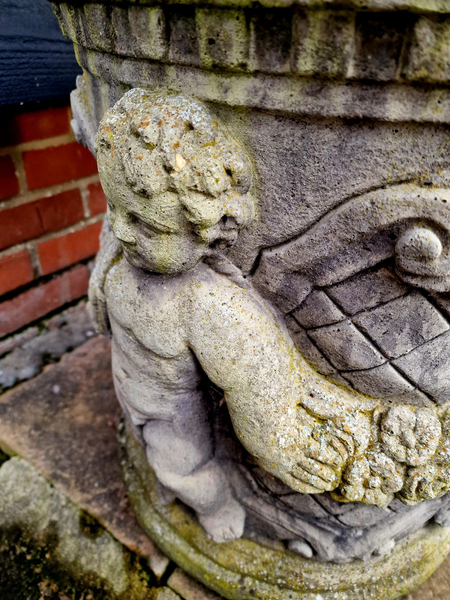 A Pair Of Cherub Garden Urns