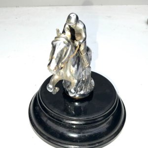 A super bronze jumping horse & rider car mascot. Made from chromed bronze, in the form of a horse & rider jumping a fence, this mascot has been mounted on a black marble base early 20th century, makers name on horses flank, conditions used showing some blemishes, placed on black base for display looks inspiring, standing 18 cm high to include base, length of 14 cm bases diameter 16 cm.