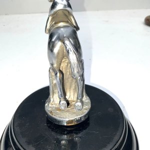 A super bronze jumping horse & rider car mascot. Made from chromed bronze, in the form of a horse & rider jumping a fence, this mascot has been mounted on a black marble base early 20th century, makers name on horses flank, conditions used showing some blemishes, placed on black base for display looks inspiring, standing 18 cm high to include base, length of 14 cm bases diameter 16 cm.