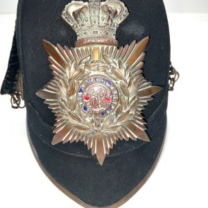 Royal military academy sandhurst officer badge and 1878 pattern blue cloth helmet, complete with all gilt metal fittings, crowned star pattern plates with gilt mounts. Good condition, being old has the odd blemish,