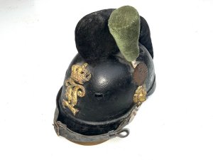 Rare early helmet. This is a 19th-century bavarian m1868 raupenhelm, a military helmet also known as a "caterpillar helmet" due to its distinctive wool crest. It was worn by bavarian jäger battalions and other mounted troops. The helmet features a leather body and a gilt "l" (ludwig) monogram on the front badge, referring to king ludwig ii of bavaria. It has an original wool "raupe" (caterpillar) crest and a leather chin strap. These helmets were in use from around 1800 to 1886, undergoing various modifications over time. Comes complete and in reasonable good condition and shape, size small to medium will make a rare edition to your collection and great future investment height 23 cm length 16 cm depth being 28 cm,