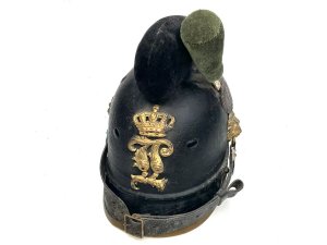 Rare early helmet. This is a 19th-century bavarian m1868 raupenhelm, a military helmet also known as a "caterpillar helmet" due to its distinctive wool crest. It was worn by bavarian jäger battalions and other mounted troops. The helmet features a leather body and a gilt "l" (ludwig) monogram on the front badge, referring to king ludwig ii of bavaria. It has an original wool "raupe" (caterpillar) crest and a leather chin strap. These helmets were in use from around 1800 to 1886, undergoing various modifications over time. Comes complete and in reasonable good condition and shape, size small to medium will make a rare edition to your collection and great future investment height 23 cm length 16 cm depth being 28 cm,