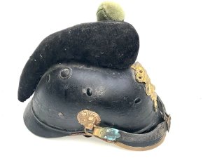 Rare early helmet. This is a 19th-century bavarian m1868 raupenhelm, a military helmet also known as a "caterpillar helmet" due to its distinctive wool crest. It was worn by bavarian jäger battalions and other mounted troops. The helmet features a leather body and a gilt "l" (ludwig) monogram on the front badge, referring to king ludwig ii of bavaria. It has an original wool "raupe" (caterpillar) crest and a leather chin strap. These helmets were in use from around 1800 to 1886, undergoing various modifications over time. Comes complete and in reasonable good condition and shape, size small to medium will make a rare edition to your collection and great future investment height 23 cm length 16 cm depth being 28 cm,