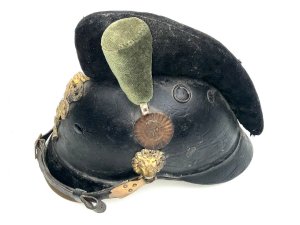 Rare early helmet. This is a 19th-century bavarian m1868 raupenhelm, a military helmet also known as a "caterpillar helmet" due to its distinctive wool crest. It was worn by bavarian jäger battalions and other mounted troops. The helmet features a leather body and a gilt "l" (ludwig) monogram on the front badge, referring to king ludwig ii of bavaria. It has an original wool "raupe" (caterpillar) crest and a leather chin strap. These helmets were in use from around 1800 to 1886, undergoing various modifications over time. Comes complete and in reasonable good condition and shape, size small to medium will make a rare edition to your collection and great future investment height 23 cm length 16 cm depth being 28 cm,