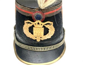 Original french officer's kepi hat french third republic republican guard model 1874 shako by barrau paris with 'paris arms' helmet plate. The french third republic was france from 1870, when the second french empire collapsed, to 1940, when france's defeat by nazi germany led to the vichy france government. Vichy was replaced by the french fourth republic. This is an original french third republic, republican guard model 1874 shako. It has a dark blue cloth over a hard body with red cloth tape chevrons on either side and around the crown, accented with gilt lace. It has a black patent leather crown and holed metal ventilation inserts. It has a patent brim with brass reinforced rim, brass chin chain with grenadier ignited grenade bosses. It has a brass city of paris front plate underneath a tri-color cockade.