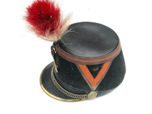 Original french officer's kepi hat french third republic republican guard model 1874 shako by barrau paris with 'paris arms' helmet plate. The french third republic was france from 1870, when the second french empire collapsed, to 1940, when france's defeat by nazi germany led to the vichy france government. Vichy was replaced by the french fourth republic. This is an original french third republic, republican guard model 1874 shako. It has a dark blue cloth over a hard body with red cloth tape chevrons on either side and around the crown, accented with gilt lace. It has a black patent leather crown and holed metal ventilation inserts. It has a patent brim with brass reinforced rim, brass chin chain with grenadier ignited grenade bosses. It has a brass city of paris front plate underneath a tri-color cockade.
