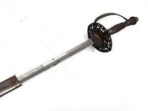 Early 18th century, this gentleman's swords in quite good condition, the three edged blade has the odd blemish that will polish out, the scabbards complete though showing some restoration, the overall length from tip to tips 99 cm across the guard is 7 cm height at guard being 9 cm blades from steels tip to top of handles 97cm and is beautifully engraved on all three edges,