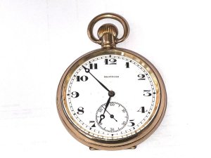 This vintage pocket watch is a luxurious timepiece, featuring a classic yellow gold case with a white dial and 12-hour dial. The swiss-made mechanical movement adds a touch of elegance, while the open face closure and one-piece strap offer a secure and stylish accessory. Perfect for formal occasions, this pocket watch exudes cultural charm and sophistication. Ideal for collectors or those who appreciate timeless craftsmanship, this piece is sure to make a statement in any gentleman's collection. Makers mayer & studeli s a swiss the name on dials the retailers, this watch is in good working order and has a low serial number, the gold plates in exceptional good condition too, reference drc3.
