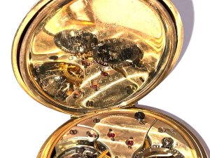 This vintage pocket watch is a luxurious timepiece, featuring a classic yellow gold case with a white dial and 12-hour dial. The swiss-made mechanical movement adds a touch of elegance, while the open face closure and one-piece strap offer a secure and stylish accessory. Perfect for formal occasions, this pocket watch exudes cultural charm and sophistication. Ideal for collectors or those who appreciate timeless craftsmanship, this piece is sure to make a statement in any gentleman's collection. Makers mayer & studeli s a swiss the name on dials the retailers, this watch is in good working order and has a low serial number, the gold plates in exceptional good condition too, reference drc3.