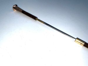 Stunning stick, partridge wood, 18 ct gold plated parts with enamelled top and high tension steel blade, condition of which is very good, late victorian. Firm strong and sturdy, length of 92 cm width across the enamel tops 3.5 cm and sticks diameter from top 1.5 cm tapering down to ferrule 1.4 cm, from the steel tip to the top of the enamel grips 91 cm,